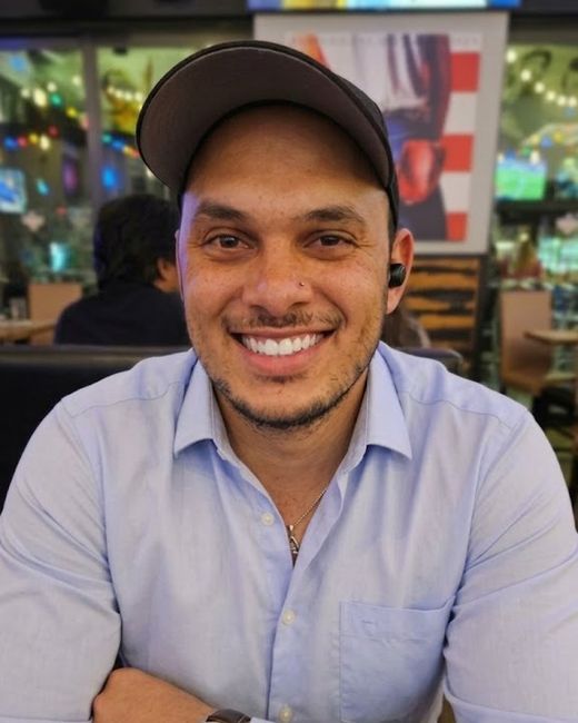 Tourell Gollab, founder of AuraType Web Design, smiling in a ball cap and light blue shirt